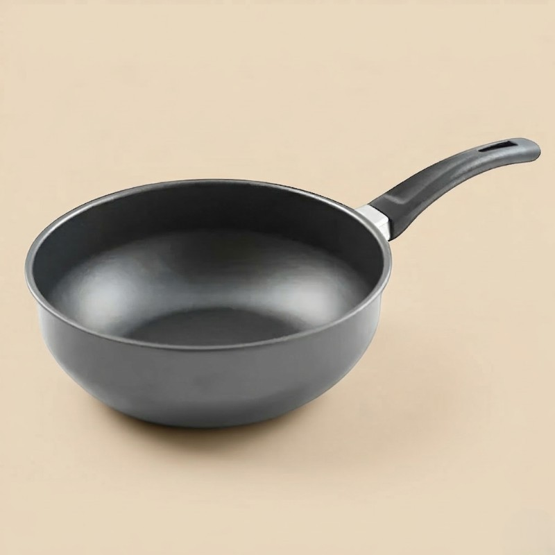 Le Yorimi, lille wok i støbt aluminium med mørk slip-let inderside og sort håndtag, på beige baggrund