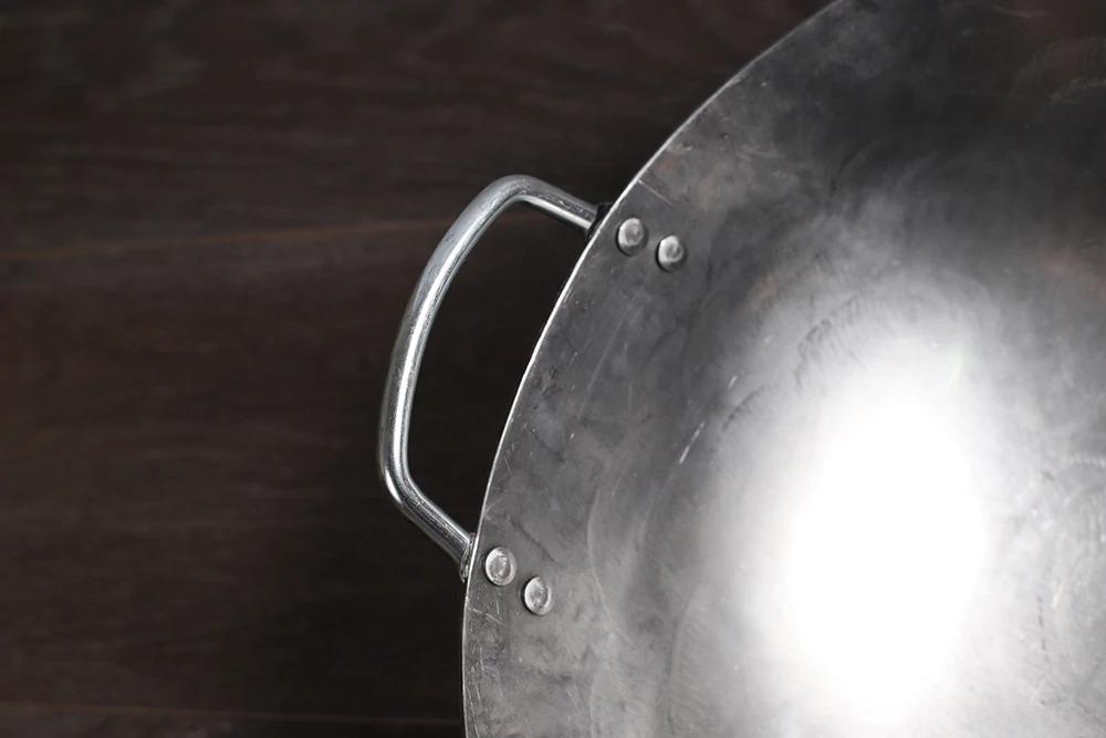 Nærbillede af den lille metalhank, der er nittet fast på kanten af woken