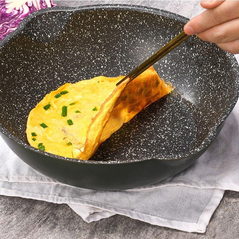 Æggekage med purløg, der løftes fri af bunden i wokken med spisepinde
